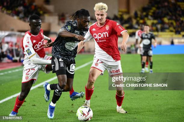 Monaco's Senegalese midfielder Krepin Diatta and Monaco's Russian midfielder Aleksandr Golovin fight for the ball with Brest's French defender...