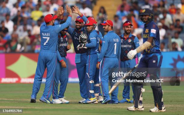 Ibrahim Zadran of Afghanistan celebrates the wicket of Dushmantha Chameera of Sri Lanka during the ICC Men's Cricket World Cup India 2023 between...
