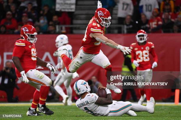 Kansas City Chiefs linebacker Leo Chenal jumps over Miami Dolphins quarterback Tua Tagovailoa during the NFL game between Miami Dolphins and Kansas...