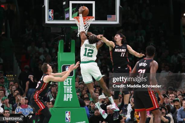 Jaime Jaquez Jr. #11 of the Miami Heat attempts to block a basket from Oshae Brissett of the Boston Celtics at TD Garden on October 27, 2023 in...