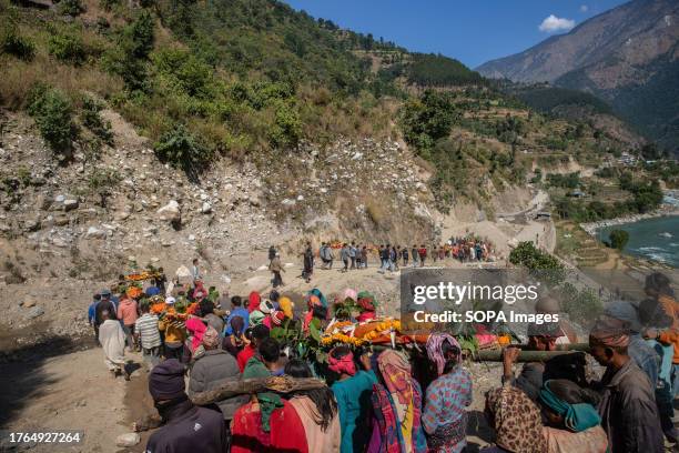Family members and villagers carry dead bodies of earthquake victims as they walk to a cremation in Jajarkot district, northwestern Nepal. As many as...