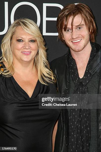 Actor Eddie Hassell and mother Sandi Hassell arrive at the "Jobs" premiere at Regal Cinemas L.A. Live on August 13, 2013 in Los Angeles, California.