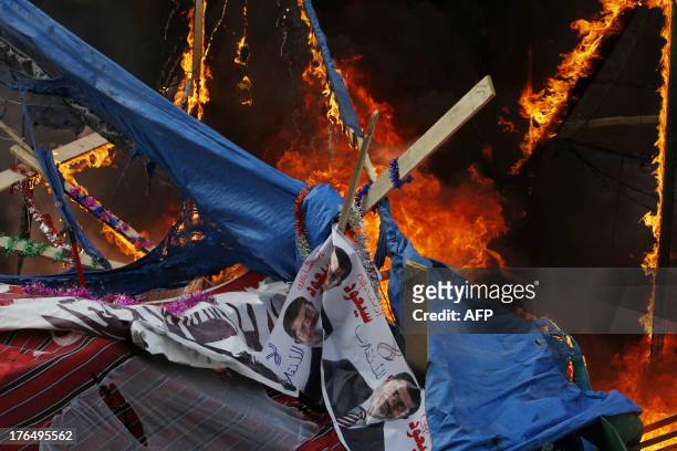 Fire rages in a protest tent as Egyptian security forces moved in to disperse supporters of Egypt's ousted president Mohamed Morsi by force in a huge...