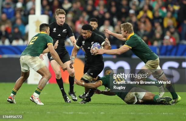 Ardie Savea of New Zealand gets tackled during the Rugby World Cup France 2023 Final match between New Zealand and South Africa at Stade de France on...