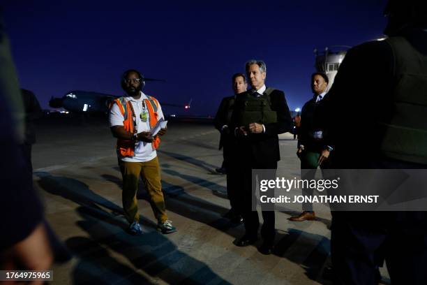 Secretary of State Antony Blinken walks with his security detail and embassy staff on the tarmac upon arrival en route to meeting Iraq's Prime...