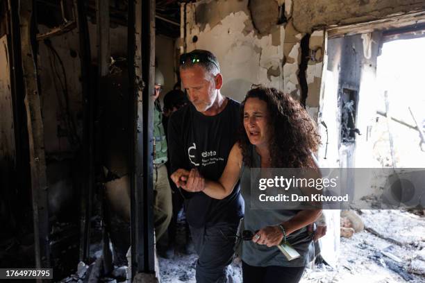 Kibbutz Nir Oz resident Hadas Kalderon, whose children have been taken hostage, and her mother and niece killed, breaks down in tears while looking...