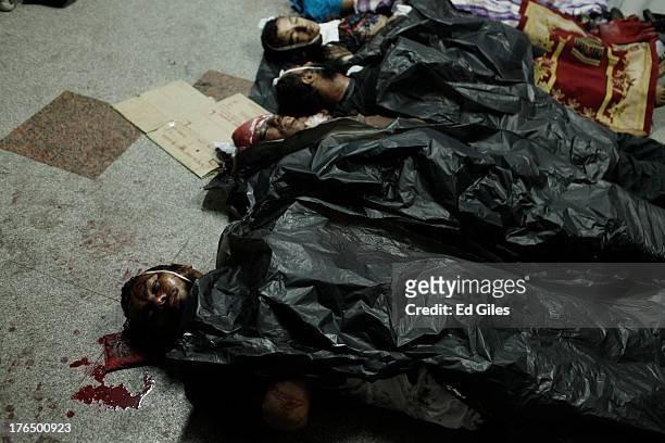 The bodies of supporters of deposed Egyptian President Mohammed Morsi lie on the floor of the Rabaa al-Adaweya Medical Centre in the Nasr City...