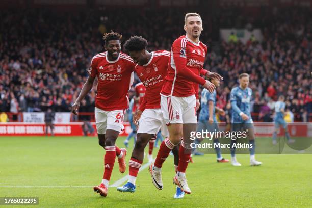 Ola Aina of Nottingham Forest celebrates scoring the opening goal with Harry Toffolo and Ibrahim Sangar during the Premier League match between...