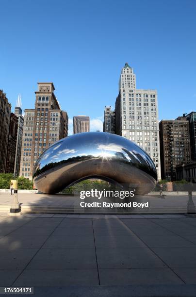 Anish Kapoor's "Cloud Gate", with buildings from the Michigan Avenue skyline in view in Chicago, Illinois on JULY 24, 2013.