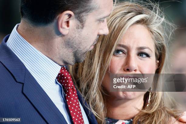 Actors Jennifer Aniston and Jason Sudeikis pose as they arrive to attend the European premiere of the film 'We're The Millers' in London on August...