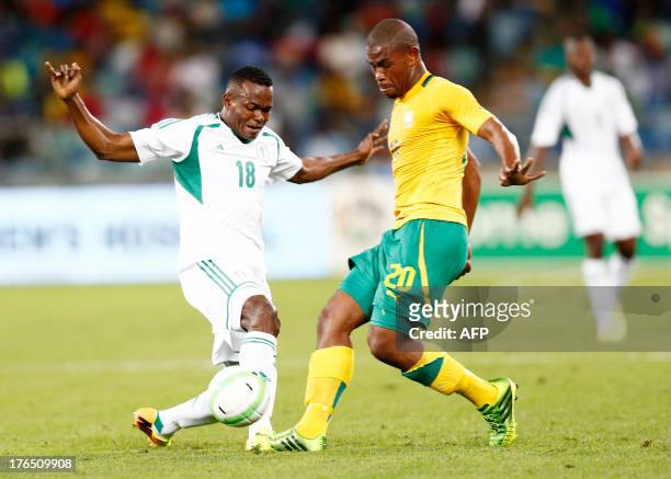 Nigeria's Obinna Nsofor vies with South Africa's Thulani Hlasthwayo during a 2013 Nelson Mandela football Challenge friendly match between South...