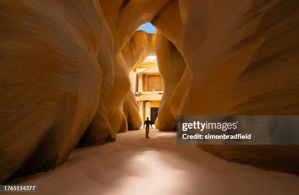 miniature man approaching miniature petra - rock formation stock pictures, royalty-free photos & images