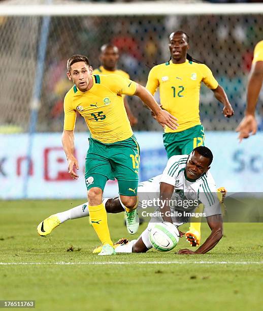 Dean Furman beats John Ogu of Nigeria during the 2013 Nelson Mandela Challenge match between South Africa and Nigeria at Moses Mabhida Stadium on...