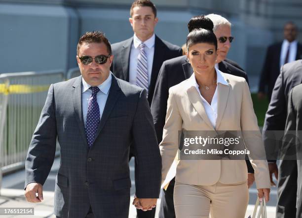 Giuseppe "Joe" Giudice and wife Teresa Giudice leave court after facing charges of defrauding lenders, illegally obtaining mortgages and other loans...