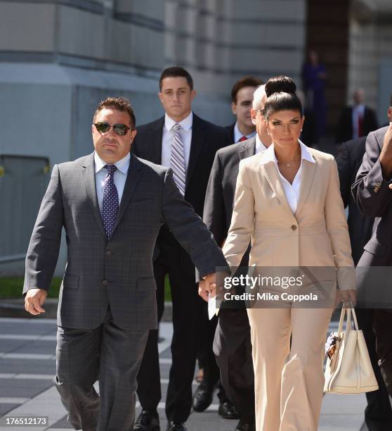 Giuseppe "Joe" Giudice and wife Teresa Giudice leave court after facing charges of defrauding lenders, illegally obtaining mortgages and other loans...