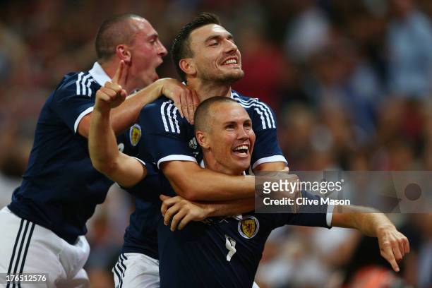 Kenny Miller of Scotland celebrates with team-mates after scoring a goal during the International Friendly match between England and Scotland at...