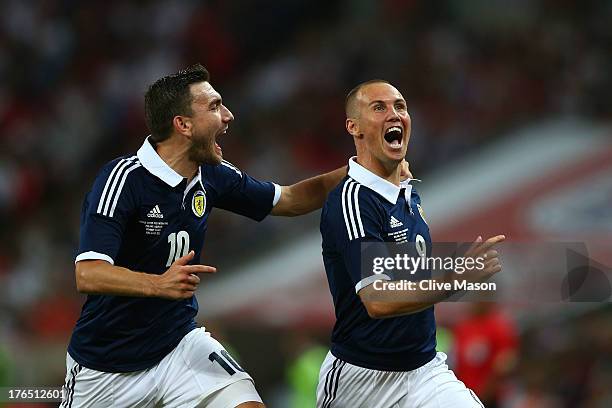 Kenny Miller of Scotland celebrates with team-mate Robert Snodgrass of Scotland after scoring a goal during the International Friendly match between...