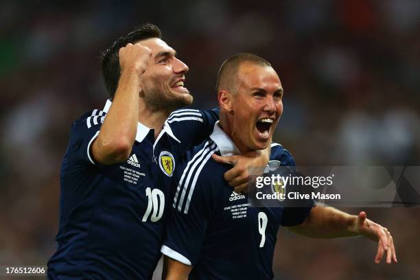 Kenny Miller of Scotland celebrates with team-mate Robert Snodgrass of Scotland after scoring a goal during the International Friendly match between...