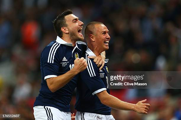 Kenny Miller of Scotland celebrates with team-mate Robert Snodgrass of Scotland after scoring a goal during the International Friendly match between...