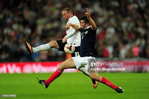 Wayne Rooney of England in action against Grant Hanley of Scotland during the International Friendly match between England and Scotland at Wembley...