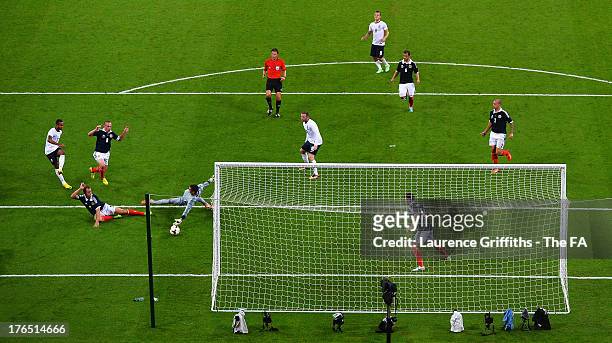 Theo Walcott of England scores the equalising goal past Allan McGregor of Scotland during the International Friendly match between England and...