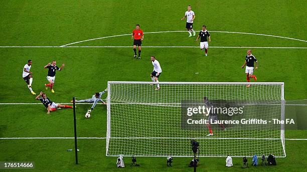 Theo Walcott of England scores the equalising goal past Allan McGregor of Scotland during the International Friendly match between England and...