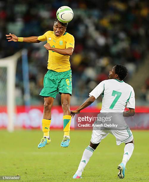 Siphiwe Tshabala of South Africa heads the ball past Ahmed Musa of Nigeria during the 2013 Nelson Mandela Challenge match between South Africa and...