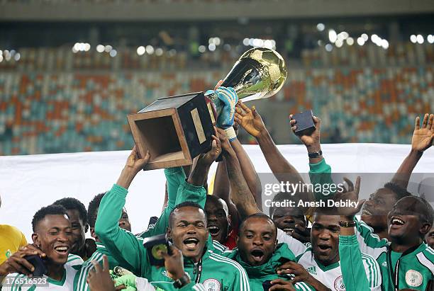 Nigeria celebrate with the trophy during the 2013 Nelson Mandela Challenge match between South Africa and Nigeria at Moses Mabhida Stadium on August...