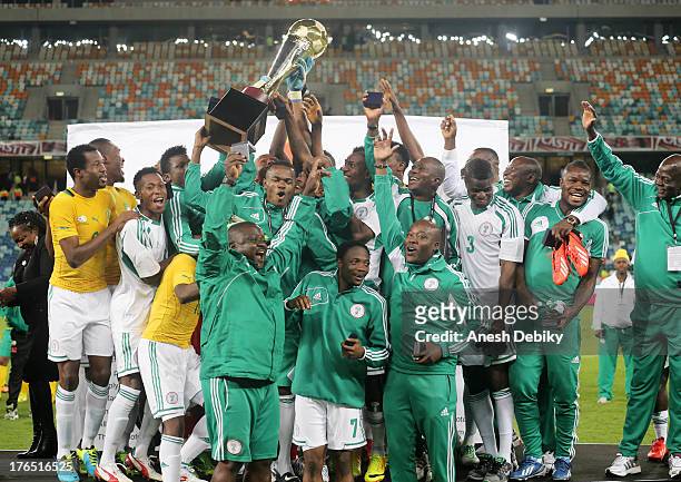 Nigeria celebrate with the trophy during the 2013 Nelson Mandela Challenge match between South Africa and Nigeria at Moses Mabhida Stadium on August...