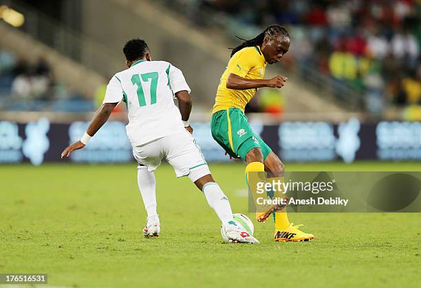 Renielwe Letsholonyane of South Africa battles with Ogenyi Onazi during the 2013 Nelson Mandela Challenge match between South Africa and Nigeria at...