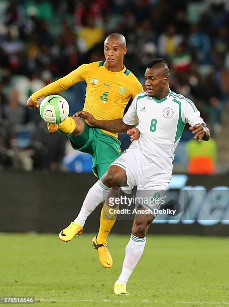 Thabo Nthethe of South Africa and Brown Ideye of Nigeria contest the ball during the 2013 Nelson Mandela Challenge match between South Africa and...