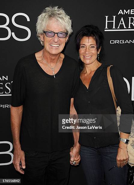Kevin Cronin of REO Speedwagon and wife Lisa Cronin attend the premiere of "Jobs" at Regal Cinemas L.A. Live on August 13, 2013 in Los Angeles,...