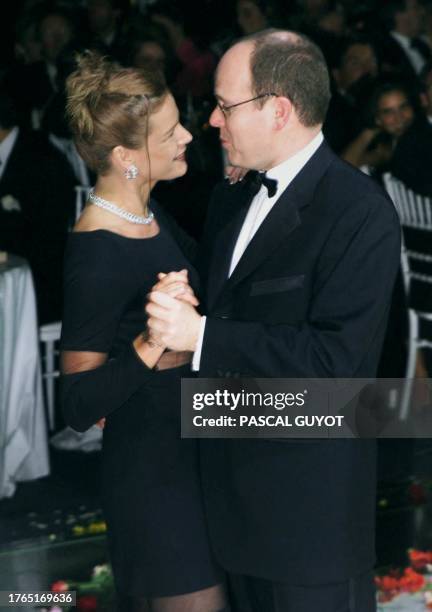 Princess Stephanie of Monaco and her brother Prince Albert dance in the early hours of 21 March 1999 at the annual charity Rose Ball in Monaco.