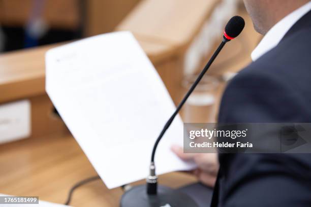 white man, possibly businessman or politician, reading a document into a microphone - government policy stock pictures, royalty-free photos & images