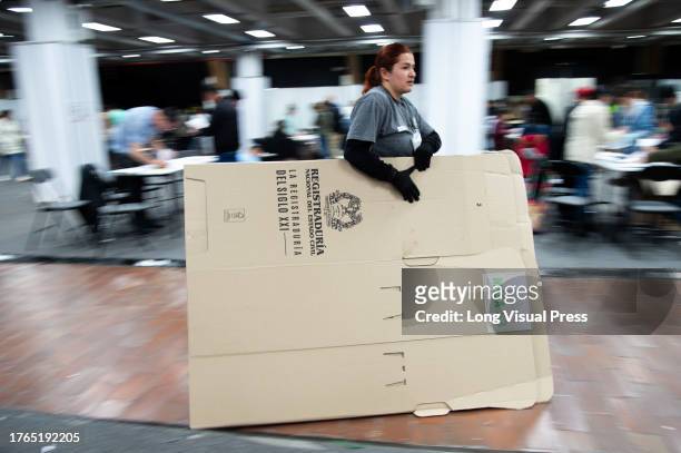 Members of the electoral jury count votes and discard all unused electoral materials during Colombia's regional elections to choose the new Mayors,...