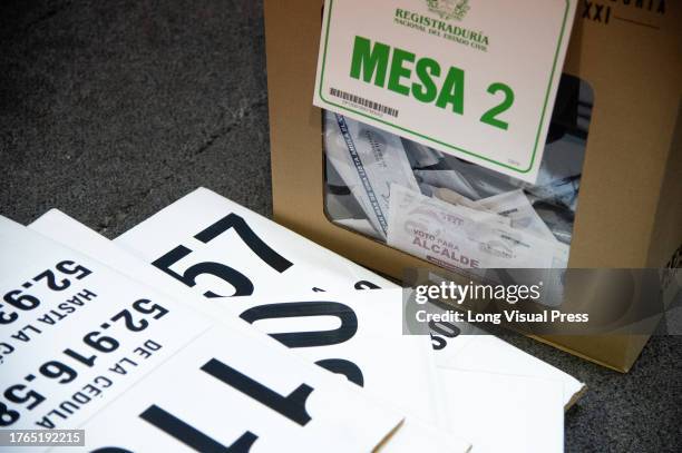 Members of the electoral jury count votes and discard all unused electoral materials during Colombia's regional elections to choose the new Mayors,...