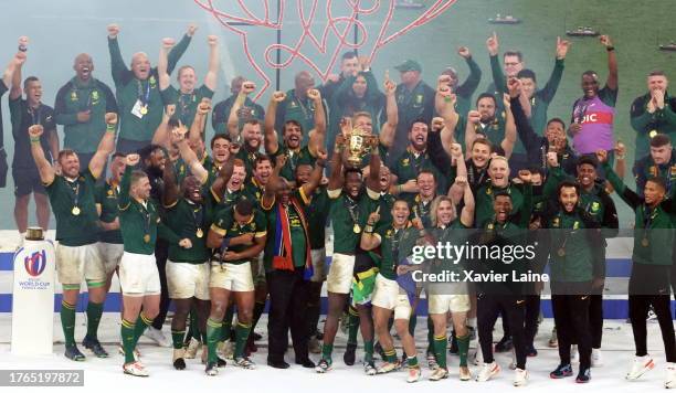 Captain, Siya Kolisi of South Africa lifts the Webb Ellis Cup with teammates following the Rugby World Cup France 2023 Gold Final match between New...