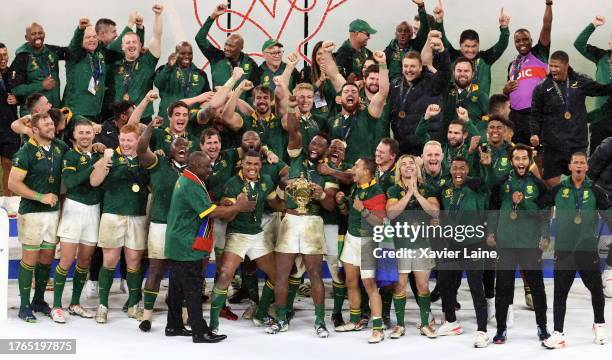 Captain, Siya Kolisi of South Africa lifts the Webb Ellis Cup with teammates following the Rugby World Cup France 2023 Gold Final match between New...