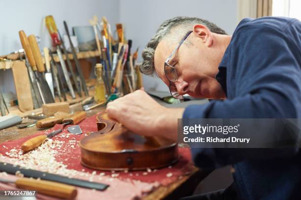 violin maker in his workshop - violin family stock pictures, royalty-free photos & images