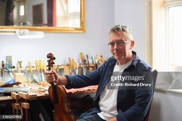 portrait of a violin maker in his workshop - violin family stock pictures, royalty-free photos & images