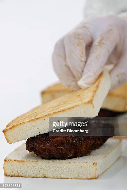 An employee assembles a toasted deep-fried-pork-cutlet sandwich, for Seven & I Holdings Co.'s 7-Eleven convenience stores, on the production line of...