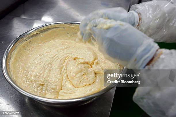 An employee makes a sauce to use as a filling in sandwiches, for Seven & I Holdings Co.'s 7-Eleven convenience stores, in the processing facility of...