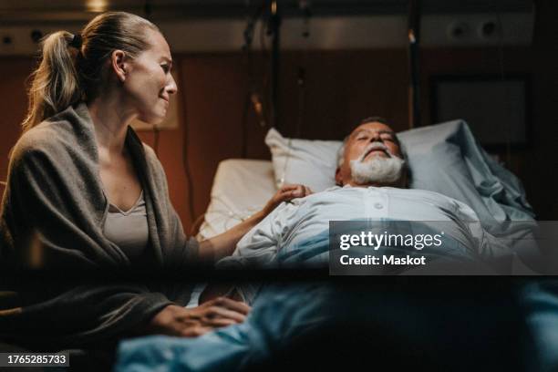 depressed mature daughter crying near father in hospital ward - stretcher stock pictures, royalty-free photos & images