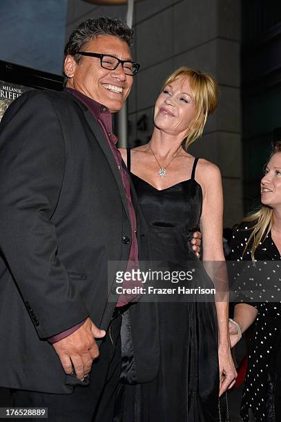 Actors Steven Bauer and Melanie Griffith arrive at the Premiere Of "Dark Tourist" at ArcLight Hollywood on August 14, 2013 in Hollywood, California.