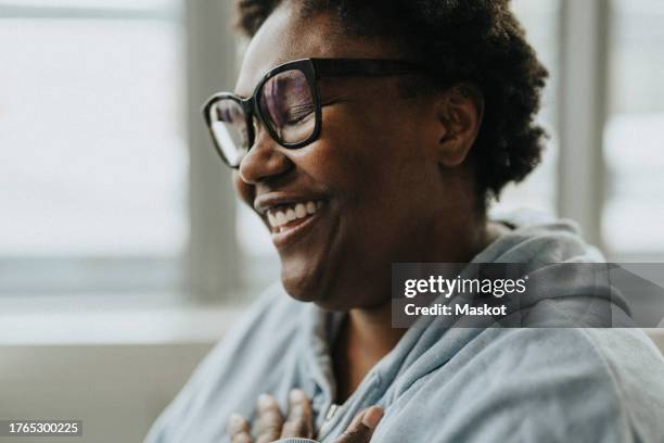 smiling female patient with eyes closed at hospital - alivio fotografías e imágenes de stock