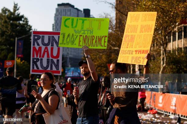 People cheer as runners pass by the Bronx borough during the 52nd Edition of the New York City Marathon on November 5, 2023.