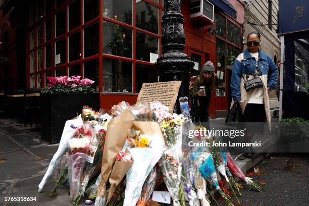 Fans pay tribute to late actor Matthew Perry outside "Friends" building on October 30, 2023 in New York City.