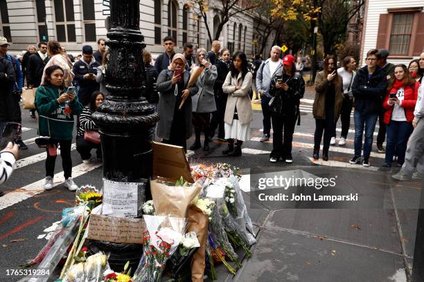 Fans pay tribute to late actor Matthew Perry outside "Friends" building on October 30, 2023 in New York City.