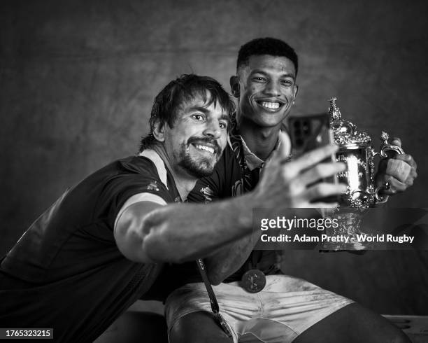 Eben Etzebeth takes a selfie on a mobile phone as he and Kurt-Lee Arendse of South Africa pose with the Webb Ellis Cup during the South Africa...