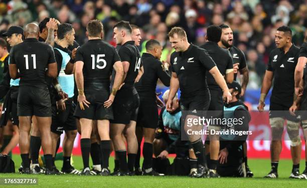 Sam Cane, the New Zealand All Blacks captain, walks off the pitch, past his team mates, after being shown a yellow card which was later upgrade to...